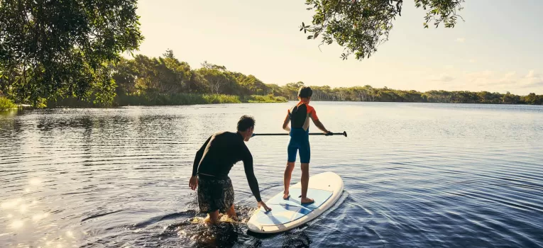 Learning to stand up paddle boar on river thames